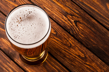 glass of dark beer on an old wooden table