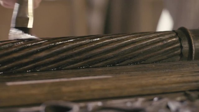 Restorer removes old varnish Old furniture