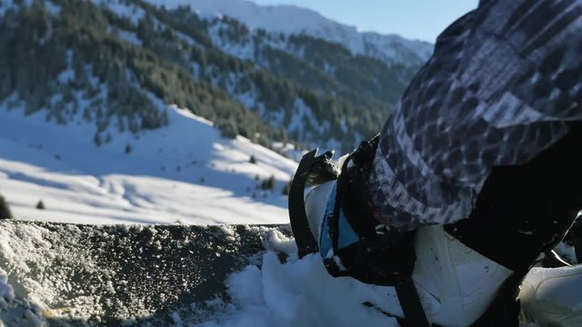 How to fasten the binding on snowboarding, how to ride. 4K footage, healthy lifestyle video. Sport