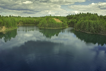 Beauty water landscape with forest lake and hills.