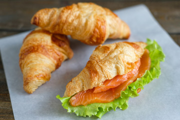croissant with salmon and salad