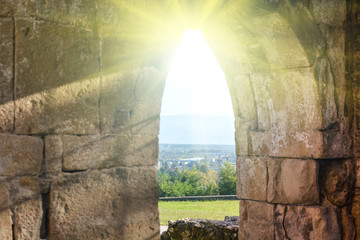 Ancient building in Kutaisi, Georgia. Medieval arch with sunshine, hope concept