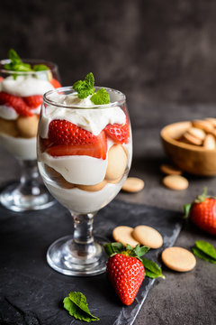 Delicious strawberry tiramisu with sponge biscuits in a glass jar