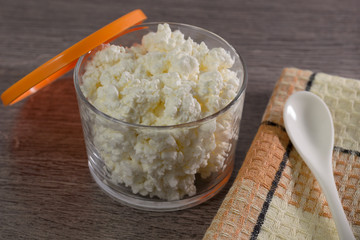 The cheese in the container on the table.