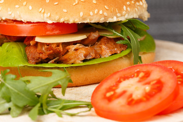 Pulled Pork Burger with Fries wedges and ketchup, closeup, low focus