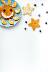 concept kid breakfast with pancake top view on white background