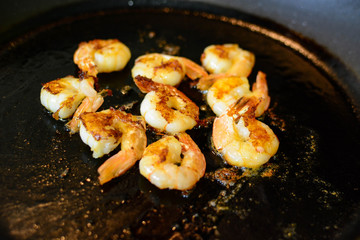 Fried shimps on frying pan, part of salad or another dish