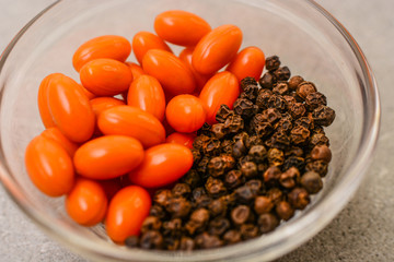 Gelatin softgels with coenzyme Q10 and black peppercorns, orange health capsules with sun beams, healthy diet and beauty concept