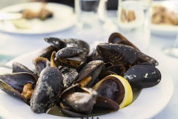 mussels steamed in a sauce, a portion of mussels psarotaverna, fish restaurant, traditional cuisine of Greece
