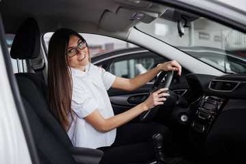 portrait of young beautiful woman sitting in the car