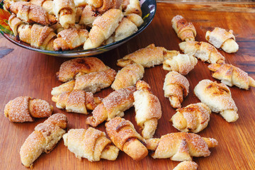 Homemade hot and fresh cookies on wooden board and bowl.
