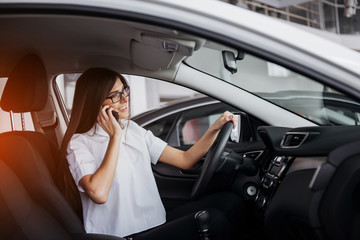 Businesswoman talking on the phone in the car.