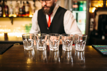 Empty glasses on wooden bar counter