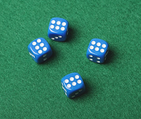 Four blue dice with number six on green background. Horizontal shoot.