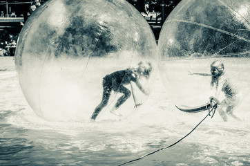 two children playing in super ball in swimming pool