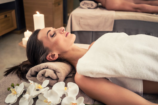 Man and woman lying down on massage beds at Asian wellness center