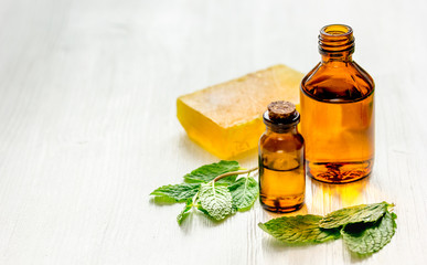 organic cosmetics with herbal extracts of mint on wooden background