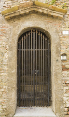 Fototapeta na wymiar Iron door with pathway in stone wall