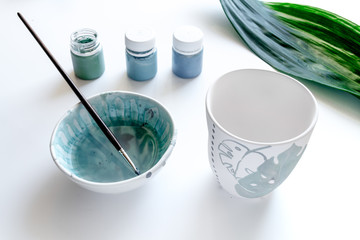 painted ceramic cup on white background