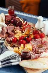 large wooden table meat, bread and vegetables