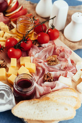 large wooden table meat, bread and vegetables