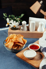 Potato chips with sauce on the table. Homemade sauces
