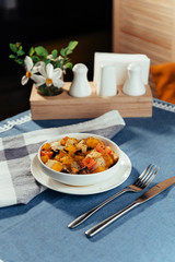 The cut fresh vegetables in a dish with spices