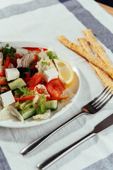 Greek salad with fresh vegetables, feta cheese and black olives