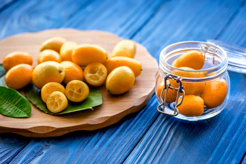 kumquat on plate at wooden table
