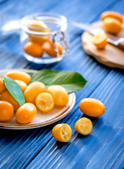 kumquat on plate at wooden table