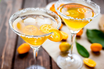cocktail with kumquat on wooden background