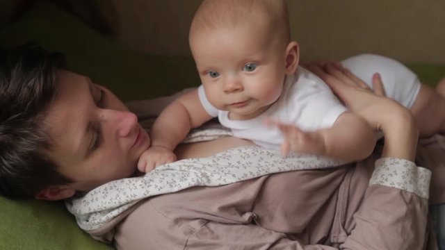 Mom plays with her litle baby