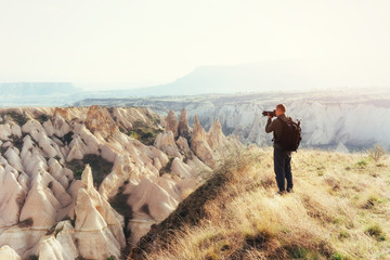 Photographer sandstone cliff and observing the natural landscape
