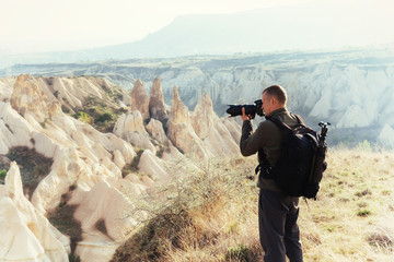 Photographer sandstone cliff and observing the natural landscape