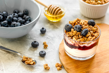 Healthy breakfast from yoghurt with muesli and berries on kitchen table