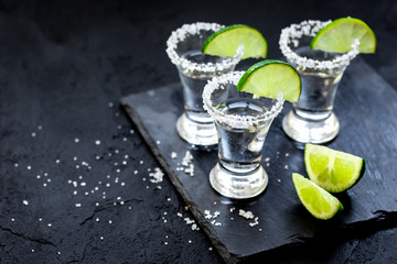 Set for tequila party with lime and salt on black background