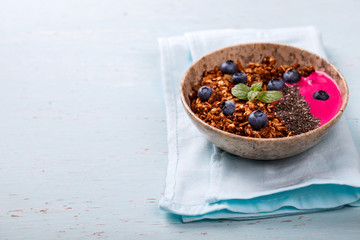 Berry Smoothie Oatmeal,Granola with Yogurt in the  bowl.Detox. Breakfast Pudding topped with goji berries, blueberries,  and chia seeds.Concept of Healthy Food.Copy space. selective focus.