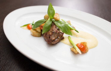 slices of duck with sauce and vegetables