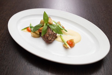 slices of duck with sauce and vegetables