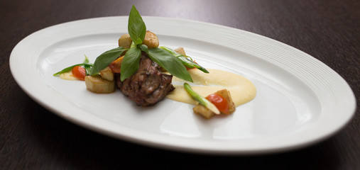 slices of duck with sauce and vegetables