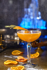 alcoholic cocktail on the basis of an orange with rosemary