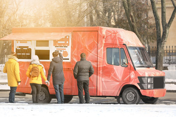 People near fast food truck on city street