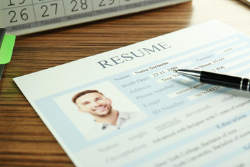 Fototapeta na wymiar Closeup of resume file on wooden table