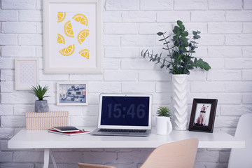 Comfortable workplace with laptop in office