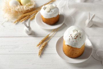 Plates with sweet Easter cakes on table