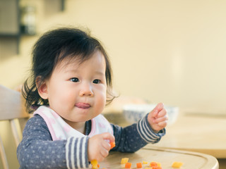 baby girl eating mashed sweet potatoes