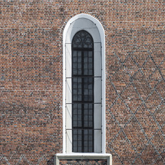 Fototapeta na wymiar Arch window with bars, 16th century