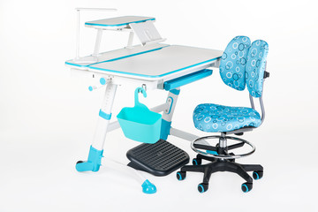 Blue chair, school desk, blue basket, desk lamp and black support under legs