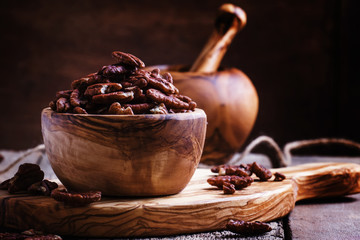 Raw pecans, vintage wooden background, selective focus