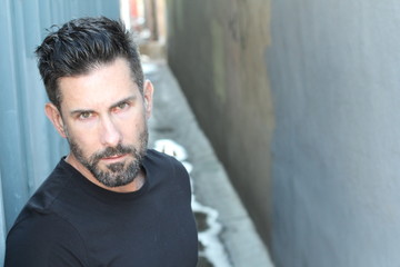 Sexy trendy man with a beard with copy space